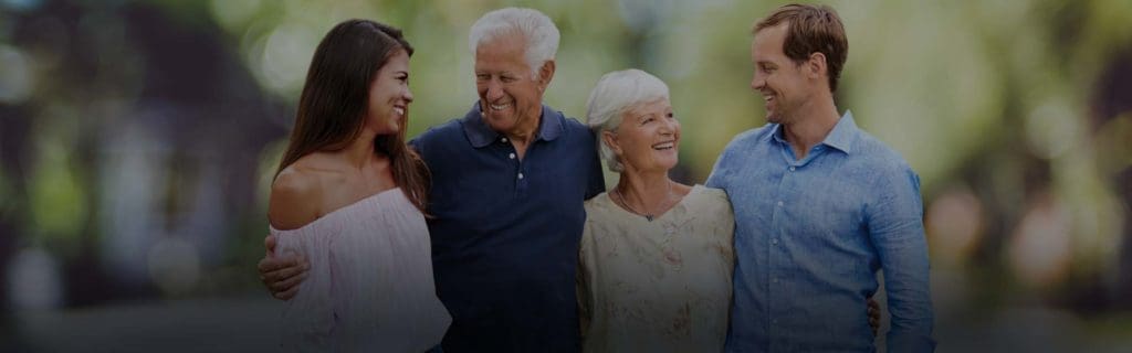 Family embracing and smiling outside