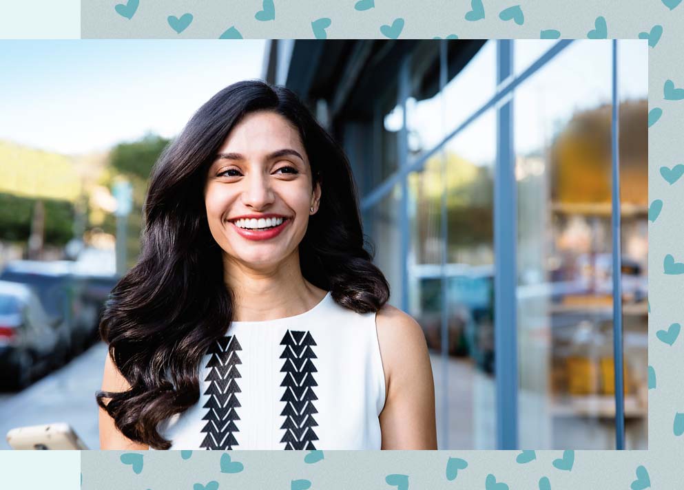 Woman in a dental chair smiling at doctor