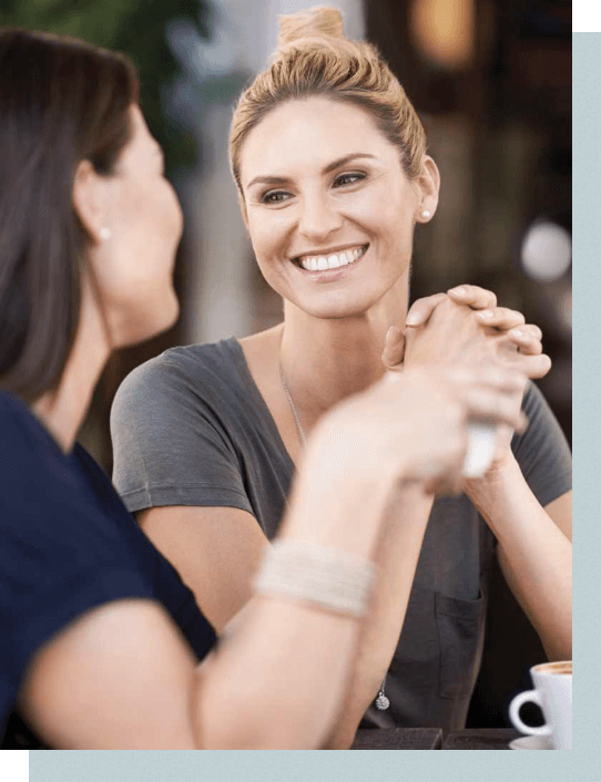 Woman smiling at another woman